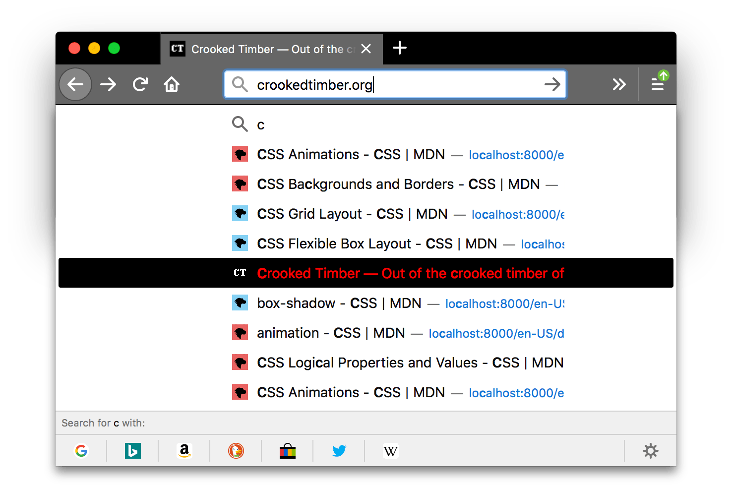 Browser firefox is black. Browser's tabs and URL bar are lighter gray with icons and text in white. A search results popup is displayed with a highlighted item's text in red with a black background. The text color of the highlighted item contrasts well with the black background color of this item.